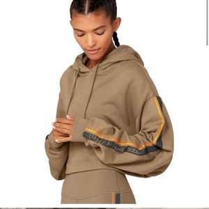Beige cropped Alo Yoga Hoodie with orange accents